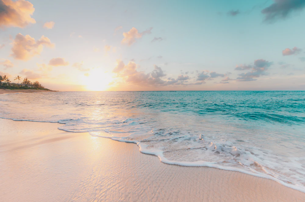 Golden sunrise over a calm ocean symbolizing market recovery after the correction