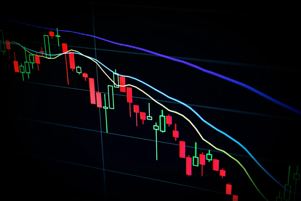 Trading desk with monitors displaying market data and charts during volatile session